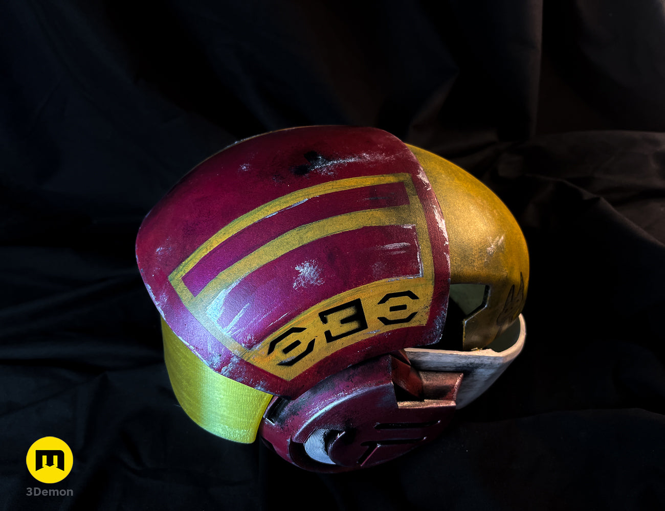Painted 3D render of Sabine Speeder Helmet - Ahsoka, maroon/yellow/gold 3D printed cosplay prop.