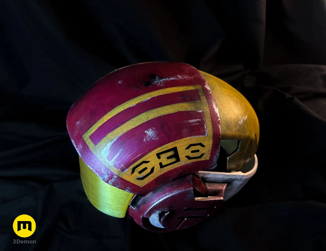 Painted 3D render of Sabine Speeder Helmet - Ahsoka, maroon/yellow/gold 3D printed cosplay prop.