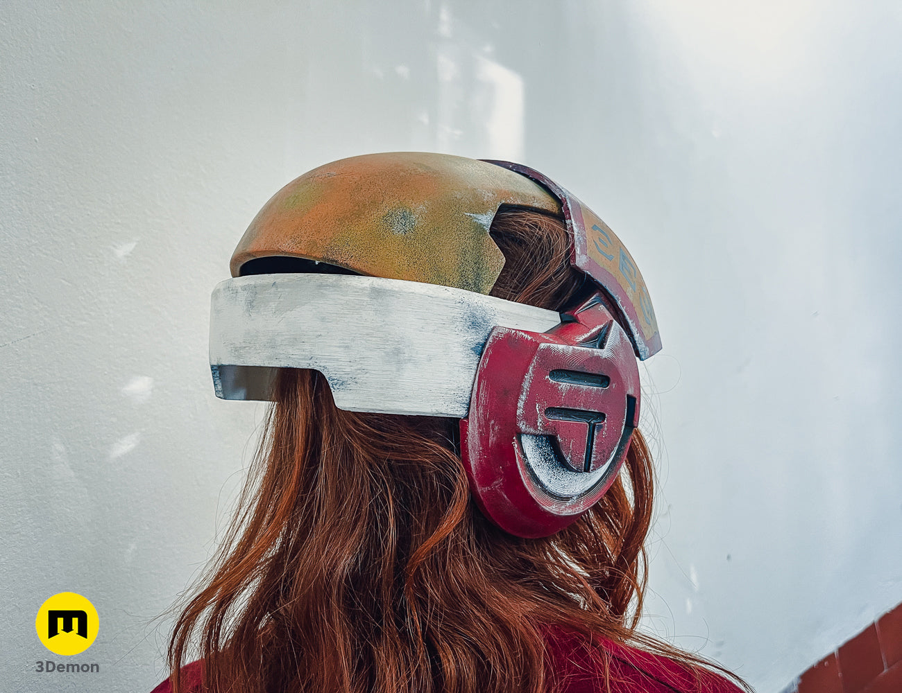 Painted 3D render of Sabine Speeder Helmet - Ahsoka, red and gold 3D printed cosplay prop.