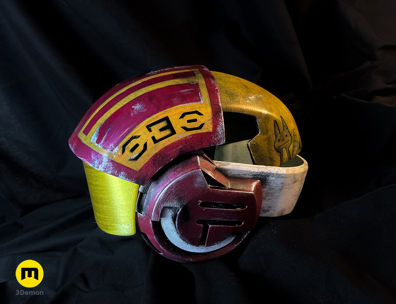 Painted 3D render of Sabine Speeder Helmet - Ahsoka, red/yellow cosplay prop with rabbit emblem.