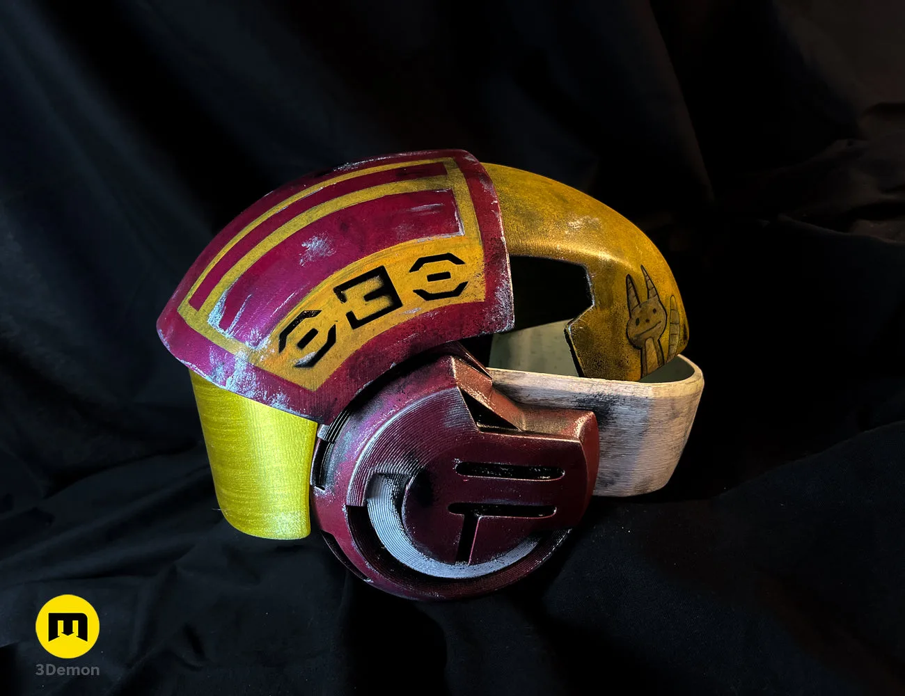 Painted 3D render of Sabine Speeder Helmet - Ahsoka, red/yellow cosplay prop with rabbit emblem.