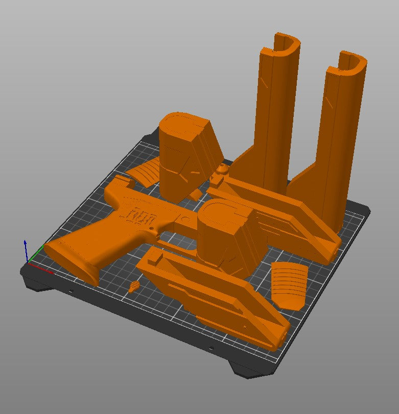 Slicer screenshot of Westar-35 Sabine Wren blasters STL, orange dual-barrelled blaster on print bed