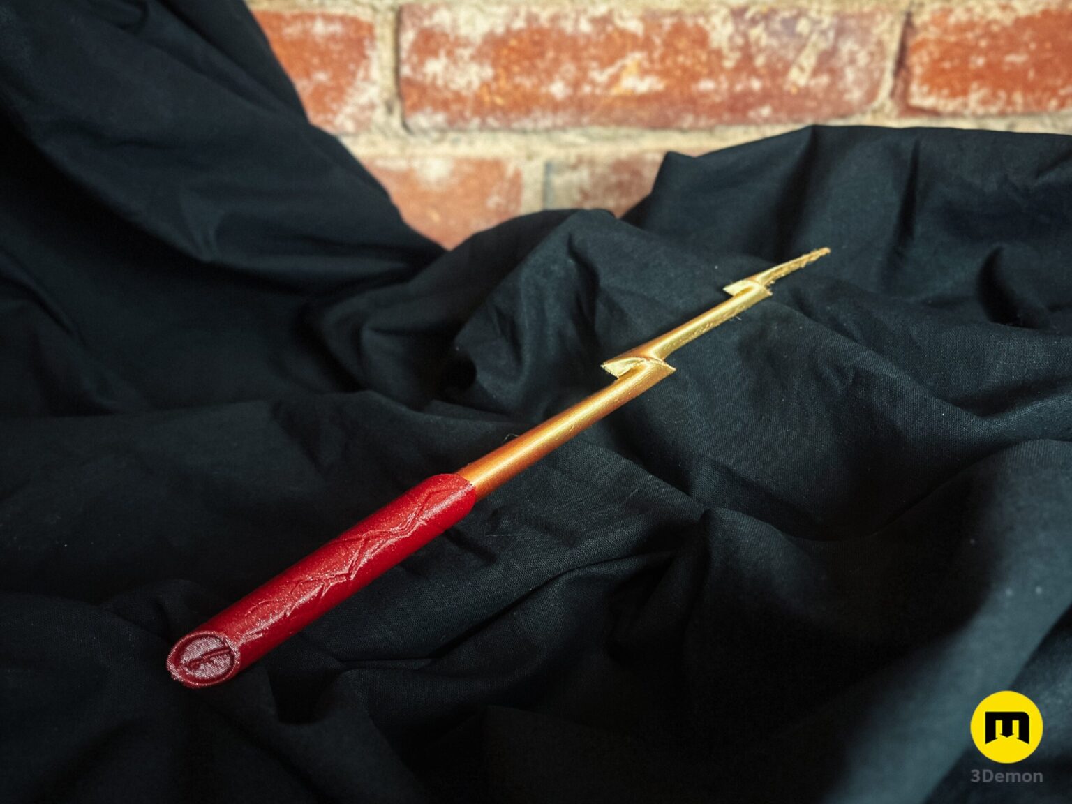 Close-up of a 3D printed Flash magic wand handle with a red lightning bolt pattern for cosplay.
