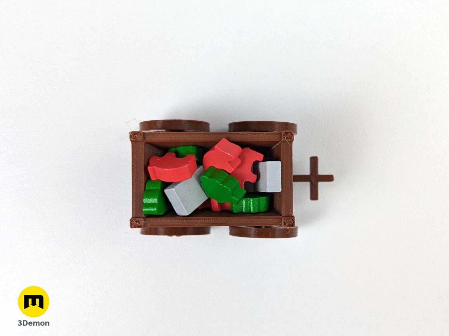 Top-down lifestyle photo of a 3D printed resource cart filled with red and green board game tokens.