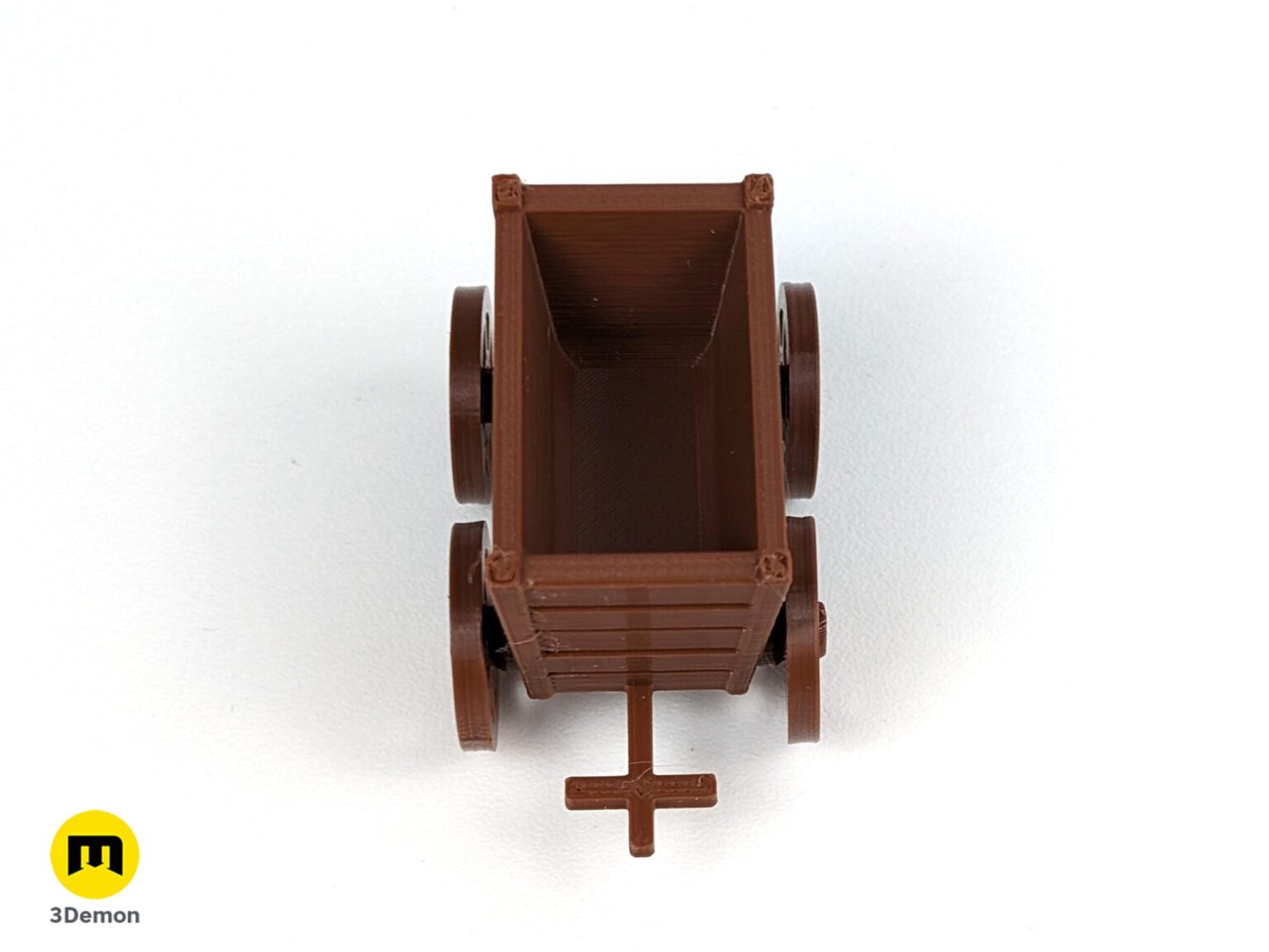 Top-down lifestyle photo of an empty brown 3D printed resource cart for the Karak II board game.