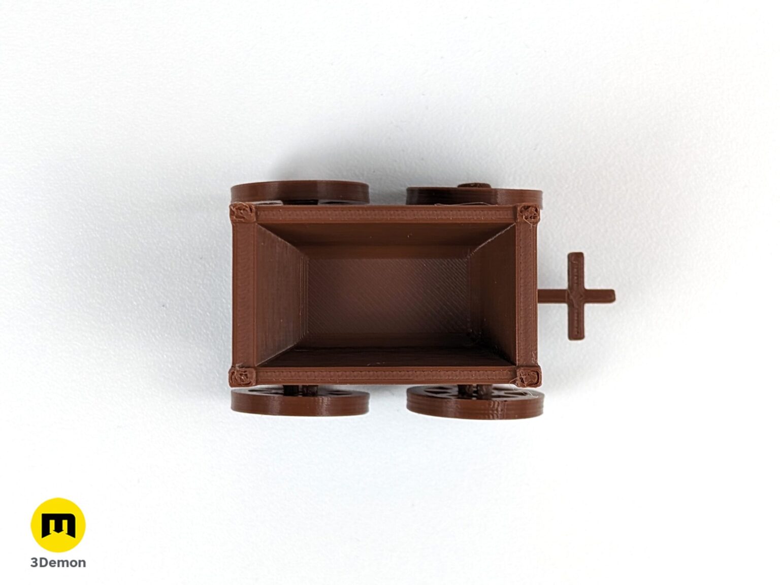 Top-down lifestyle photo of an empty brown 3D printed resource cart for board games on a white background.
