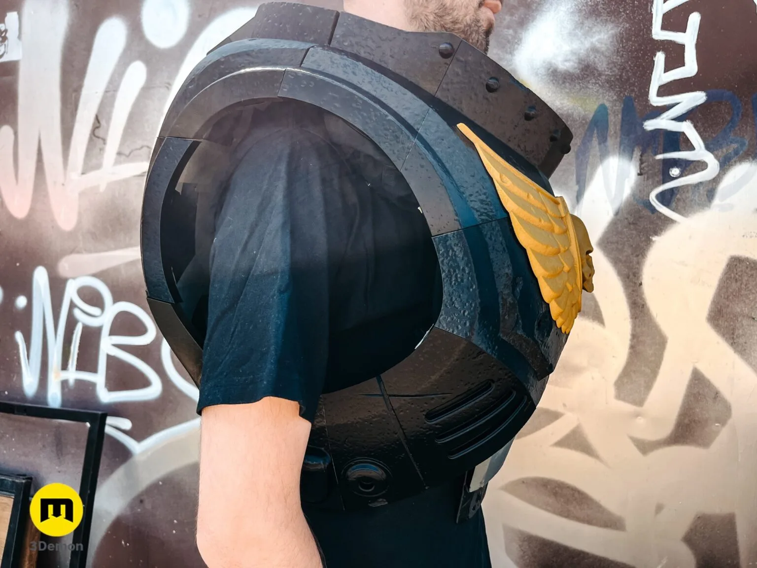 Close-up side view of a person wearing black 3D printed Space Marine chest armor showing the thick collar and Aquila.