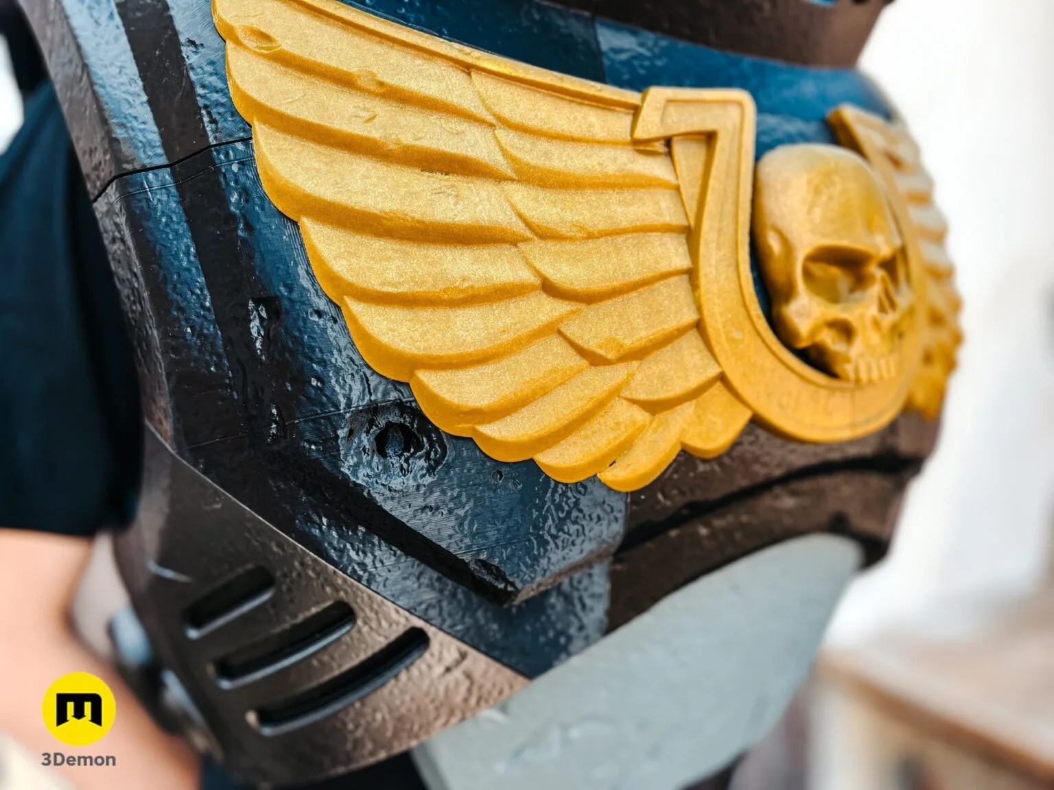 Side profile of a person wearing black 3D printed power armor chest piece with a golden Aquila.
