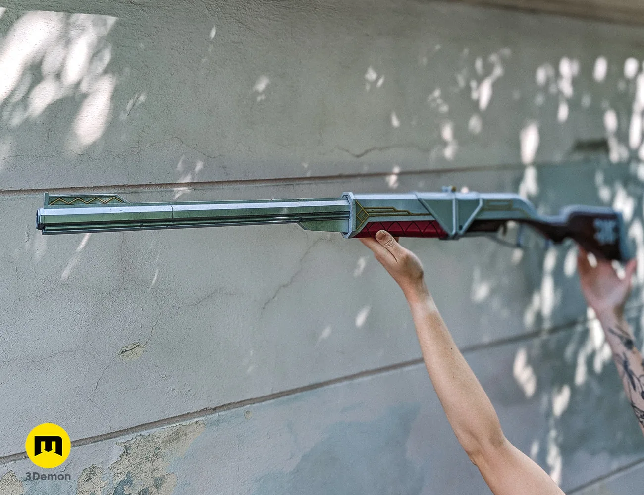 Detailed close-up of the 3D printed Caitlyn rifle's barrel, featuring silver metallic paint and gold zig-zag accents.