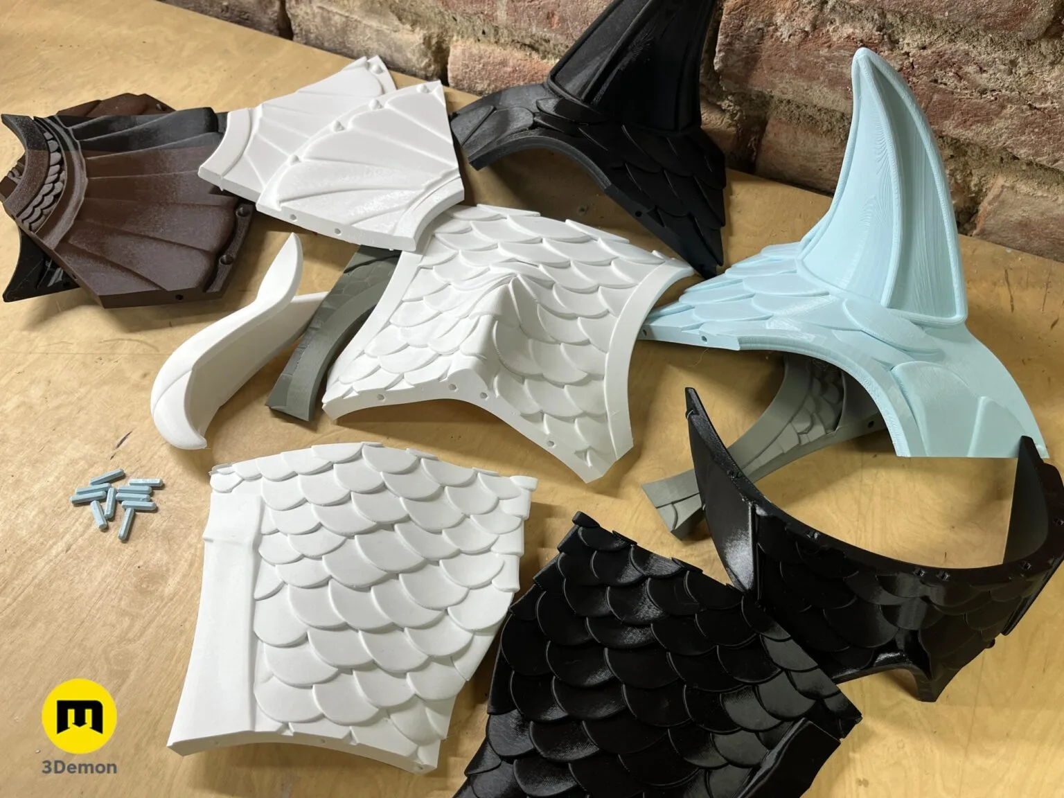 3D printed white scaled armor piece with supports on an Original Prusa i3 MK3 3D printer.