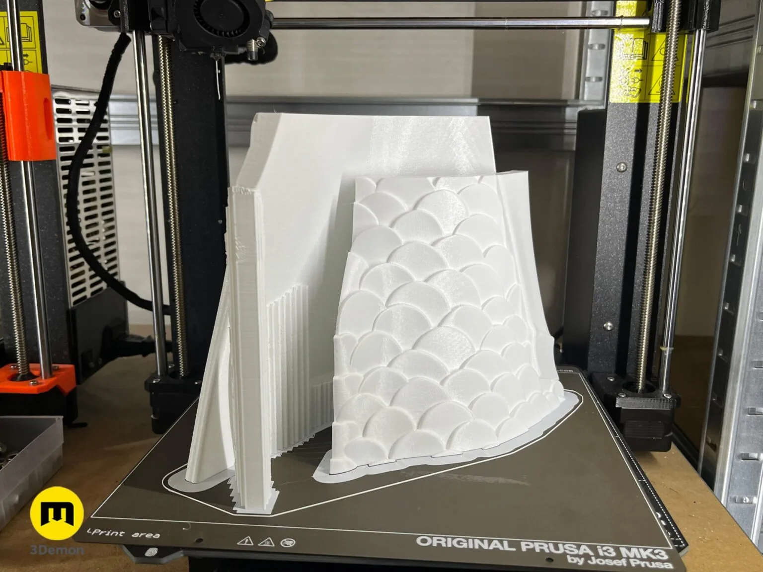 3D printed white scaled horse armor part on an Original Prusa i3 MK3 3D printer bed.