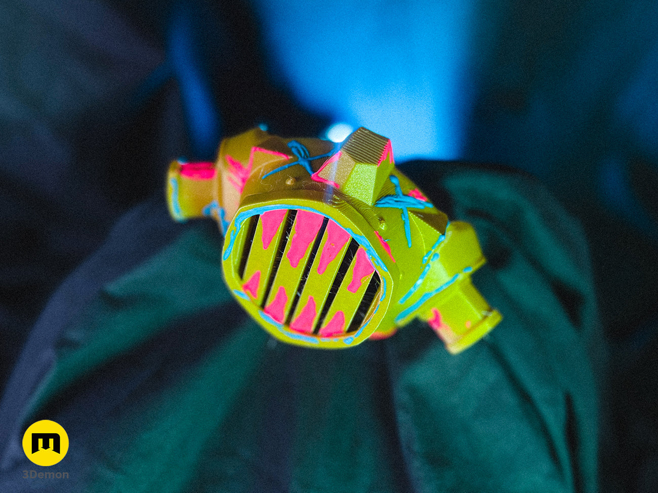 Disassembled 3D printed Jinx gas mask parts on a table, including the main mask body and circular side filters.