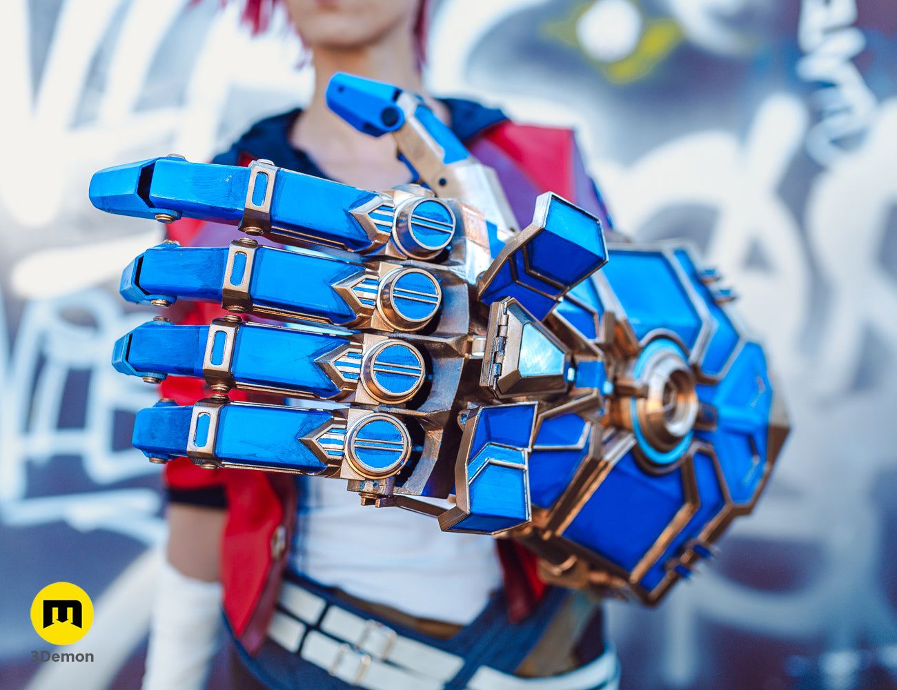 Detailed front view of the 3D printed Arcane Vi mechanical gauntlet with blue panels and gold trim.