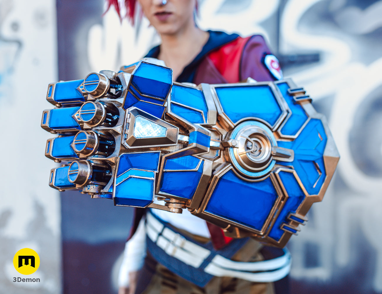 Front view of a cosplayer with pink hair showcasing the detailed 3D printed blue Arcane Vi mechanical gauntlet.