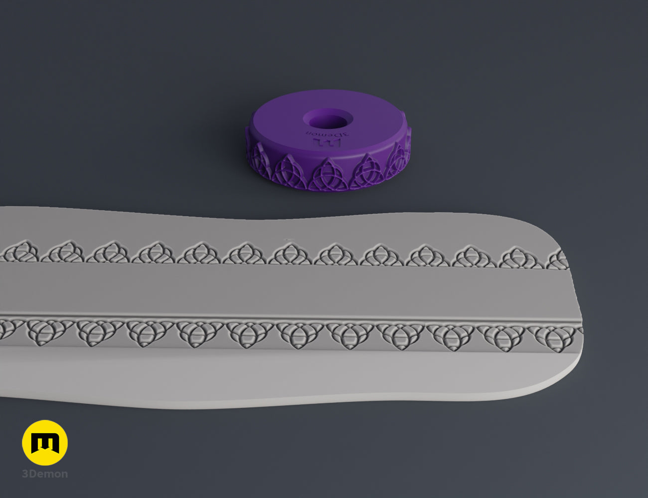 Purple 3D printed stamp wheel with a triskelion symbol and its impression on gray clay.