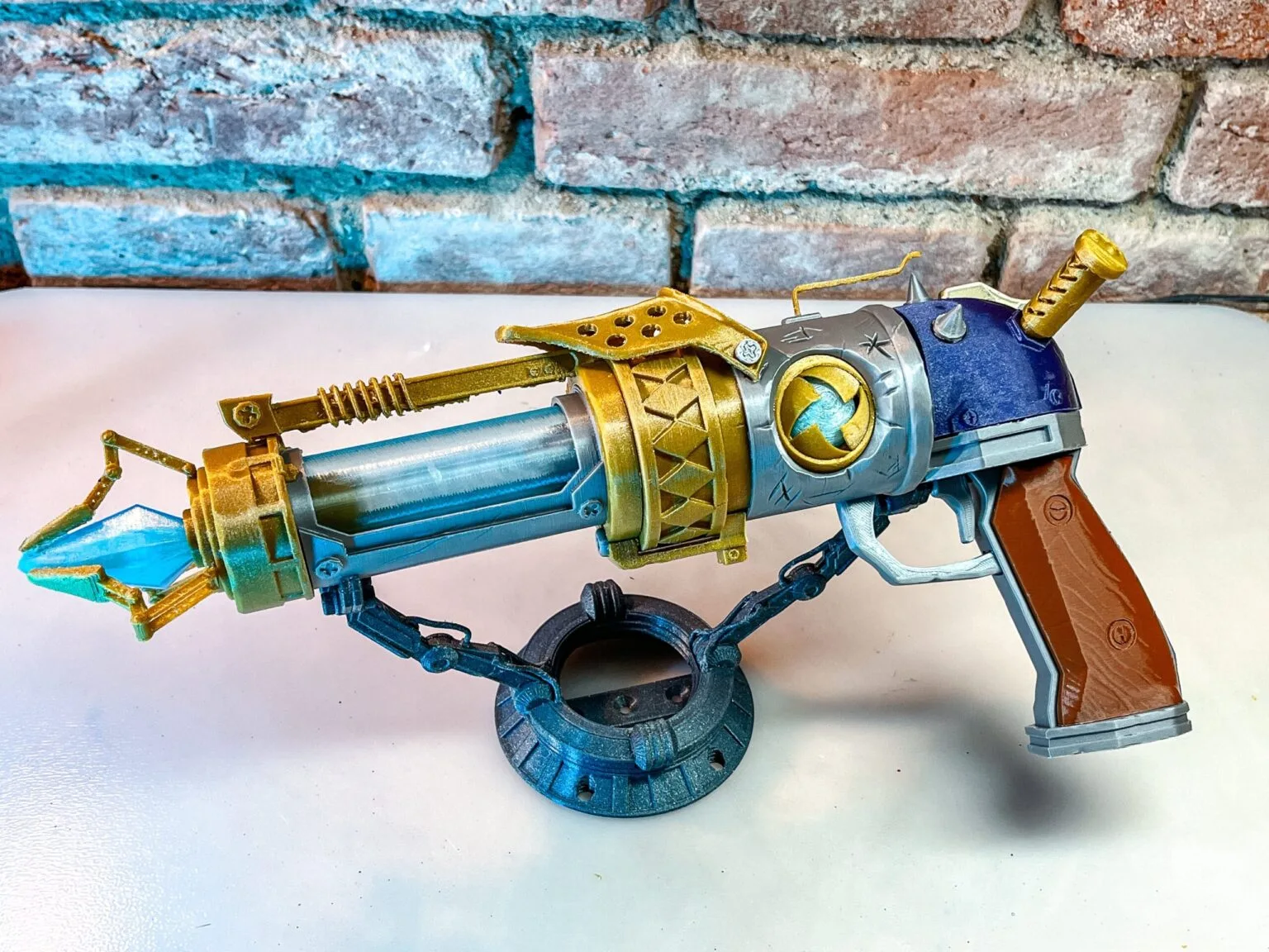 3D printed components of Jinx's blaster in various colors laid out for assembly – Jinx Arcane S2 Pistol 3D print | 3Demon