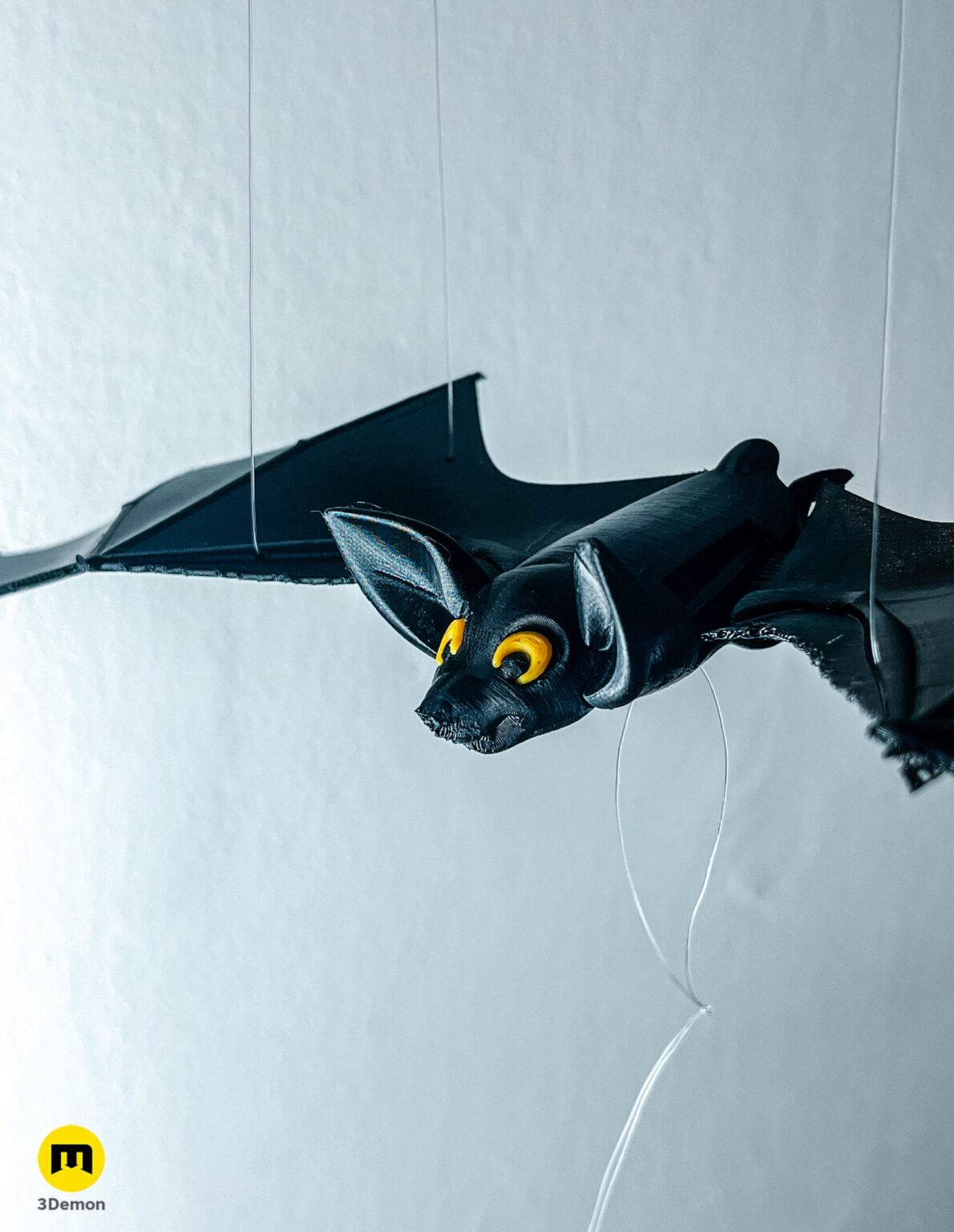 Detailed close-up of a 3D printed bat head with yellow eyes – Halloween Bat Flying Mobile 3D print | 3Demon