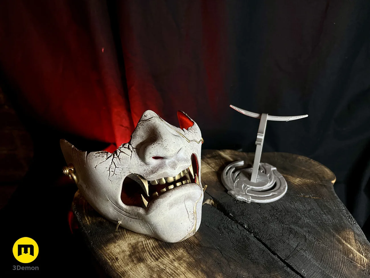 Front view of the 3D printed samurai mask next to its display stand on a rustic wooden base – Ghost of Yotei Samurai Mask 3D print | 3Demon