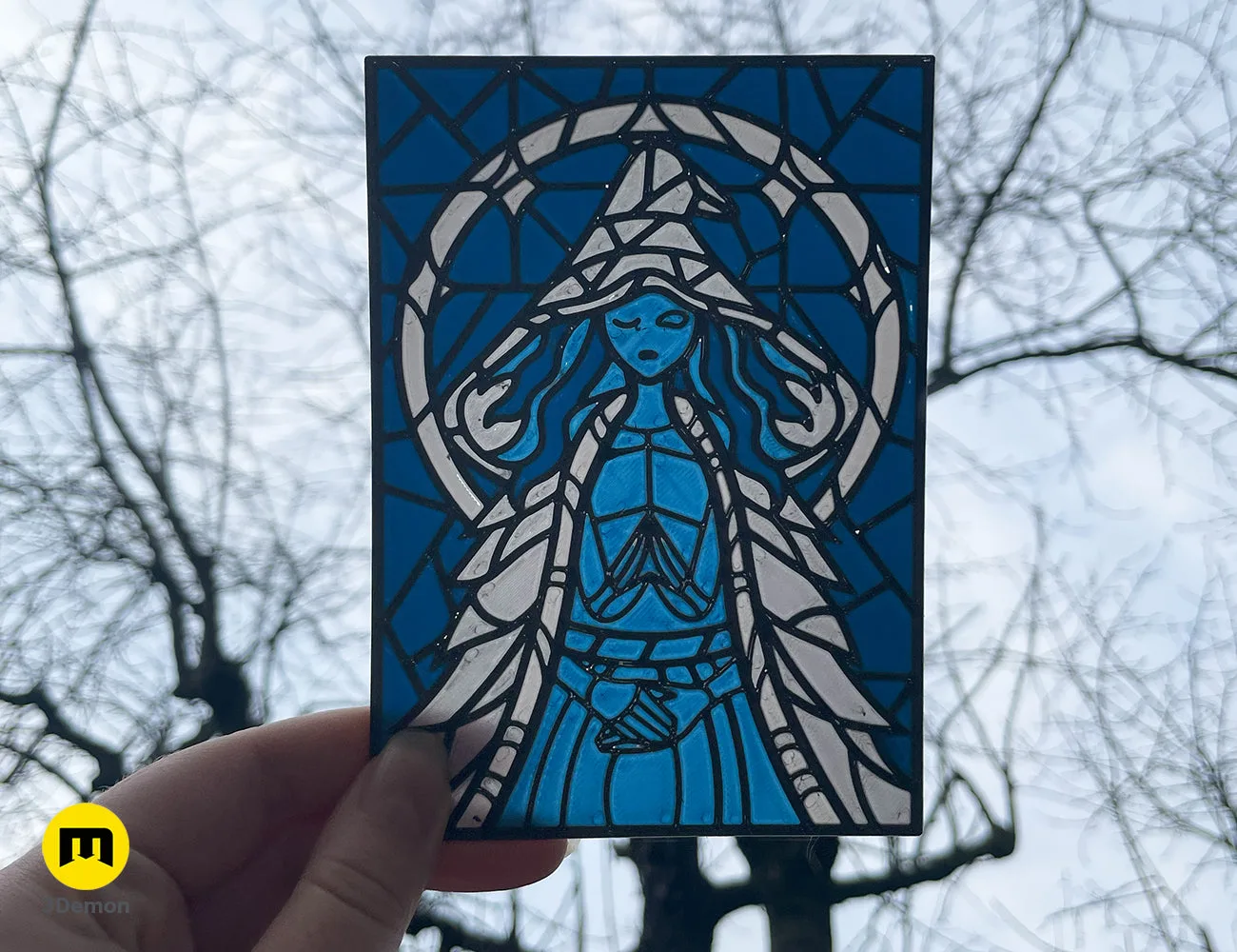 Rectangular 3D printed stained glass of Ranni the Witch held against a winter sky – Elden Ring Stained Glass 3D print | 3Demon