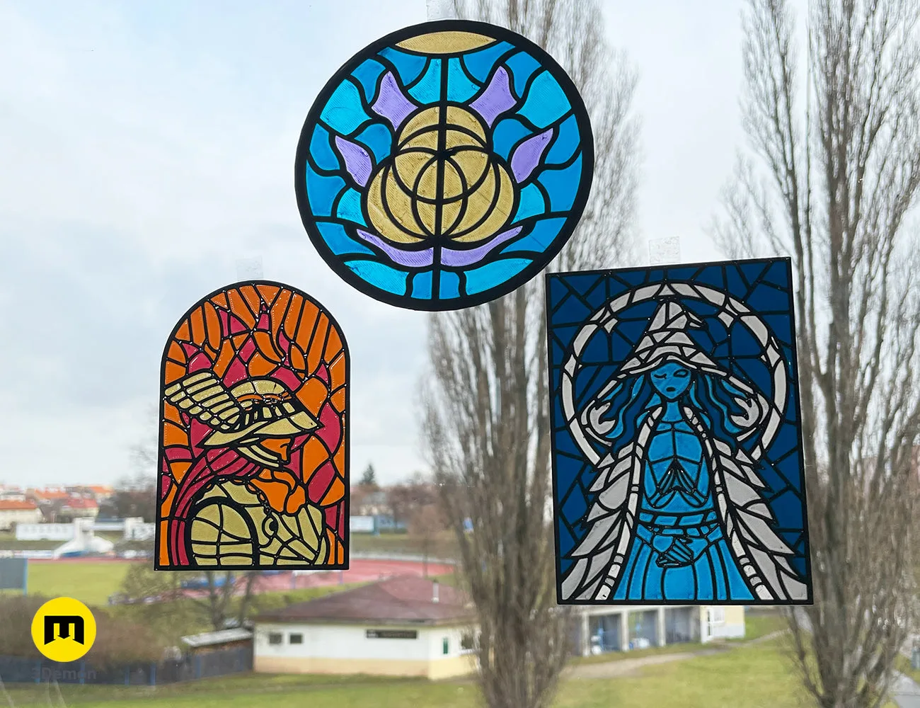 Three Elden Ring 3D printed stained glass art pieces displayed on a window pane – Elden Ring Stained Glass 3D print | 3Demon