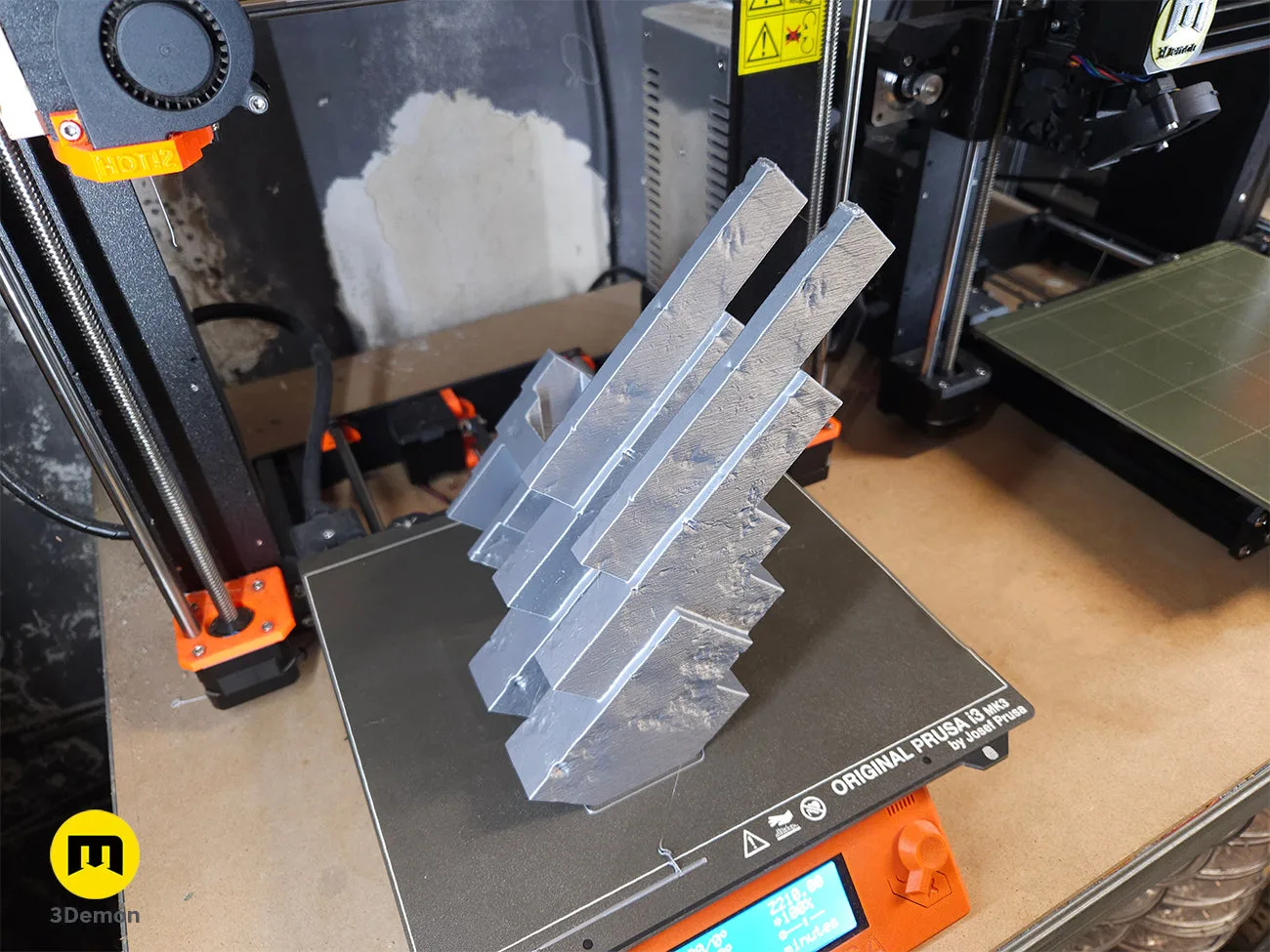 Grey 3D printed Minecraft Movie Pickaxe parts on a Prusa 3D printer bed