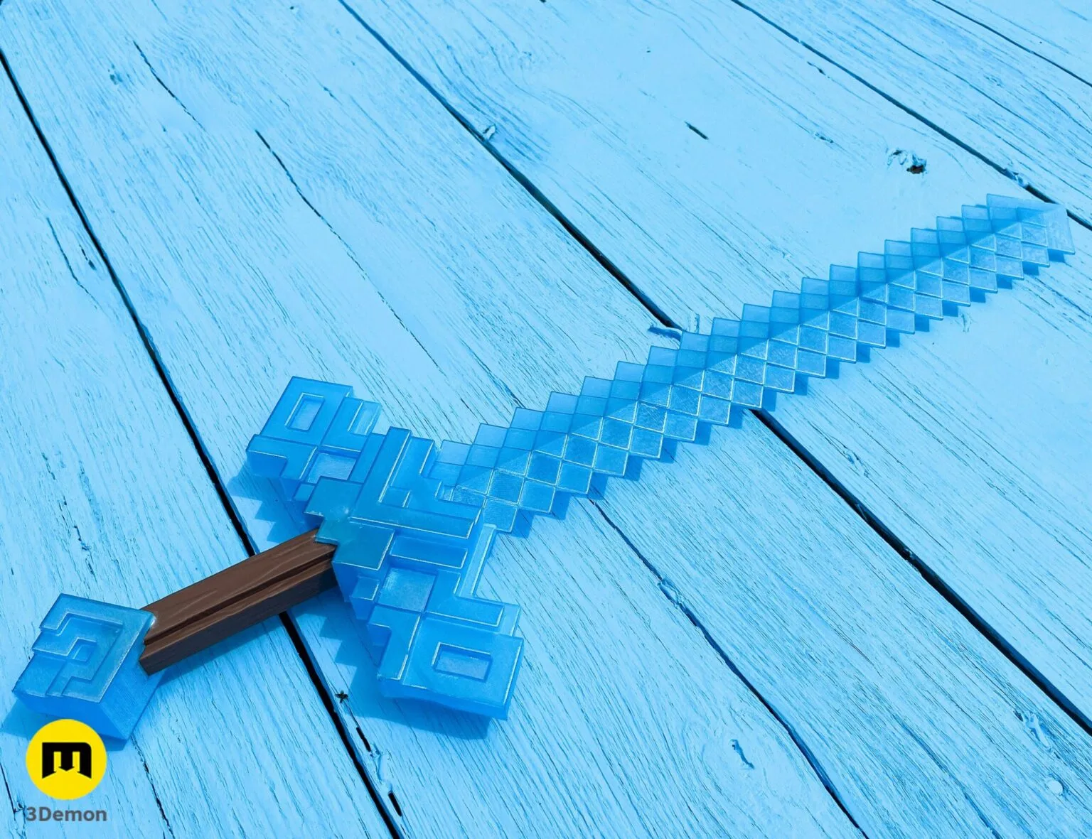 Lifestyle photo of 3D printed Minecraft Movie diamond sword (light blue) lying diagonally on light blue wooden surface showing both versions photographed in coordinated setting