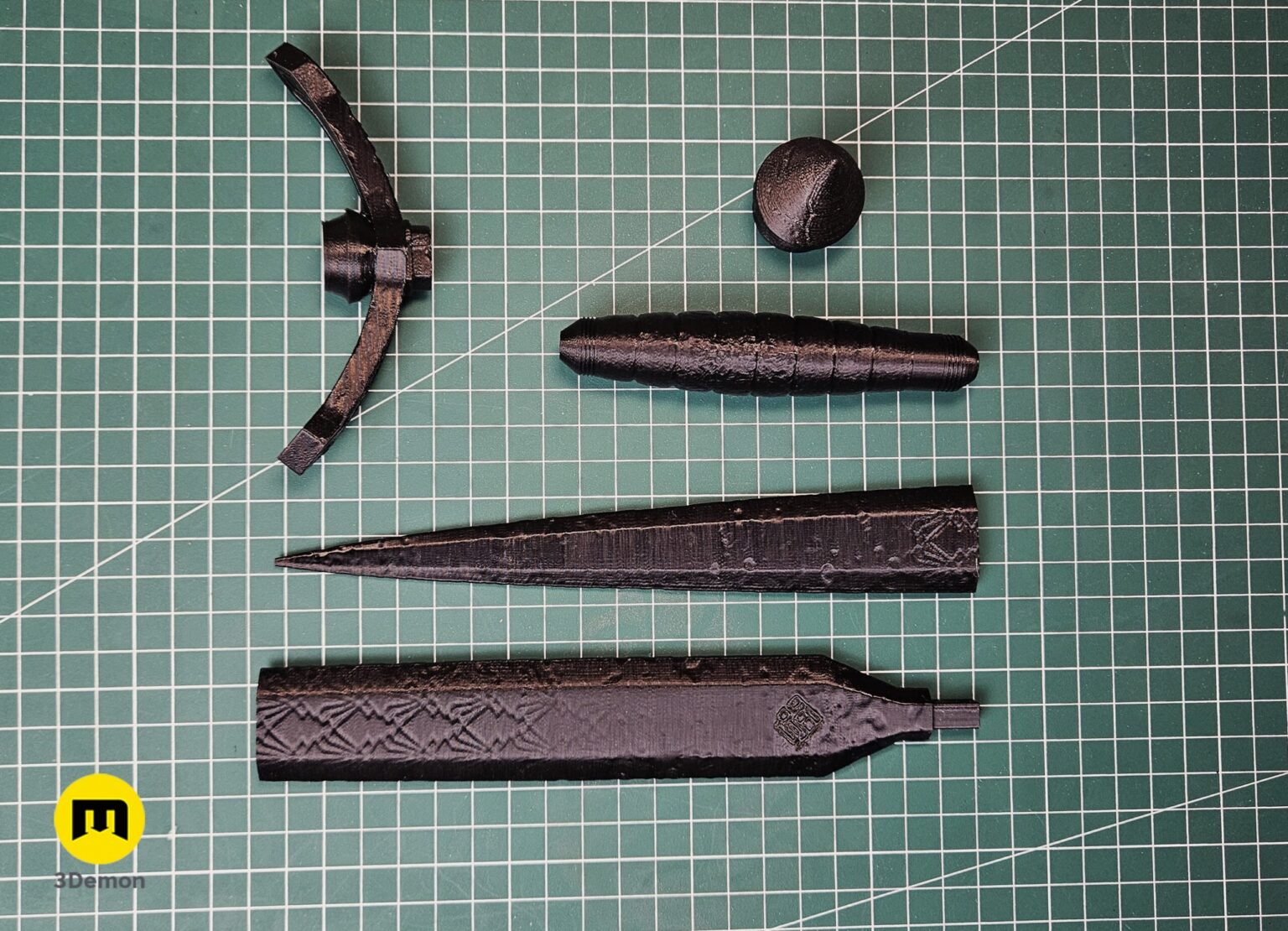 Photo of multiple 3D printed Expedition 33 Verso Dagger Verleso segments in black filament unassembled on cutting mat showing various blade crossguard and grip printable parts
