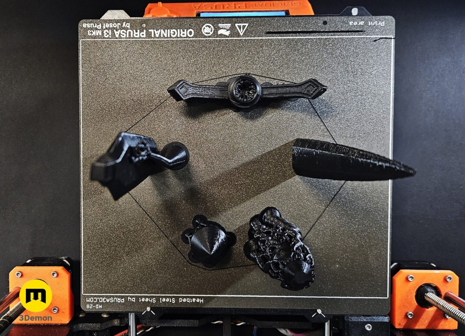 Photo of 3D printed Expedition 33 Verso Dagger Verleso parts in black filament on green cutting mat showing blade segments crossguard grip and pommel before assembly