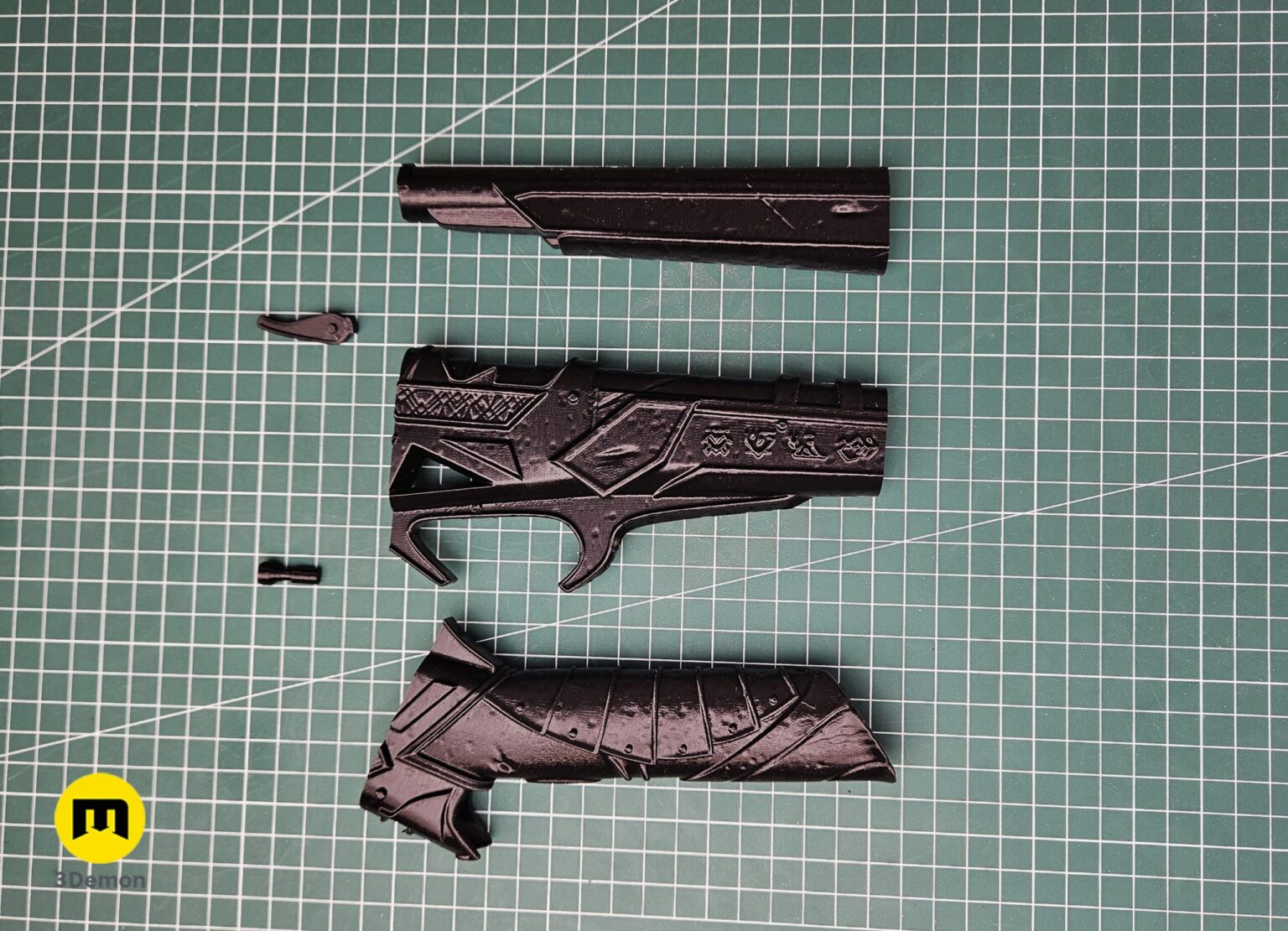 Photo of complete set of raw grey 3D printed Expedition 33 Gustave Gun parts including internal alignment pins and smaller decorative pieces before assembly