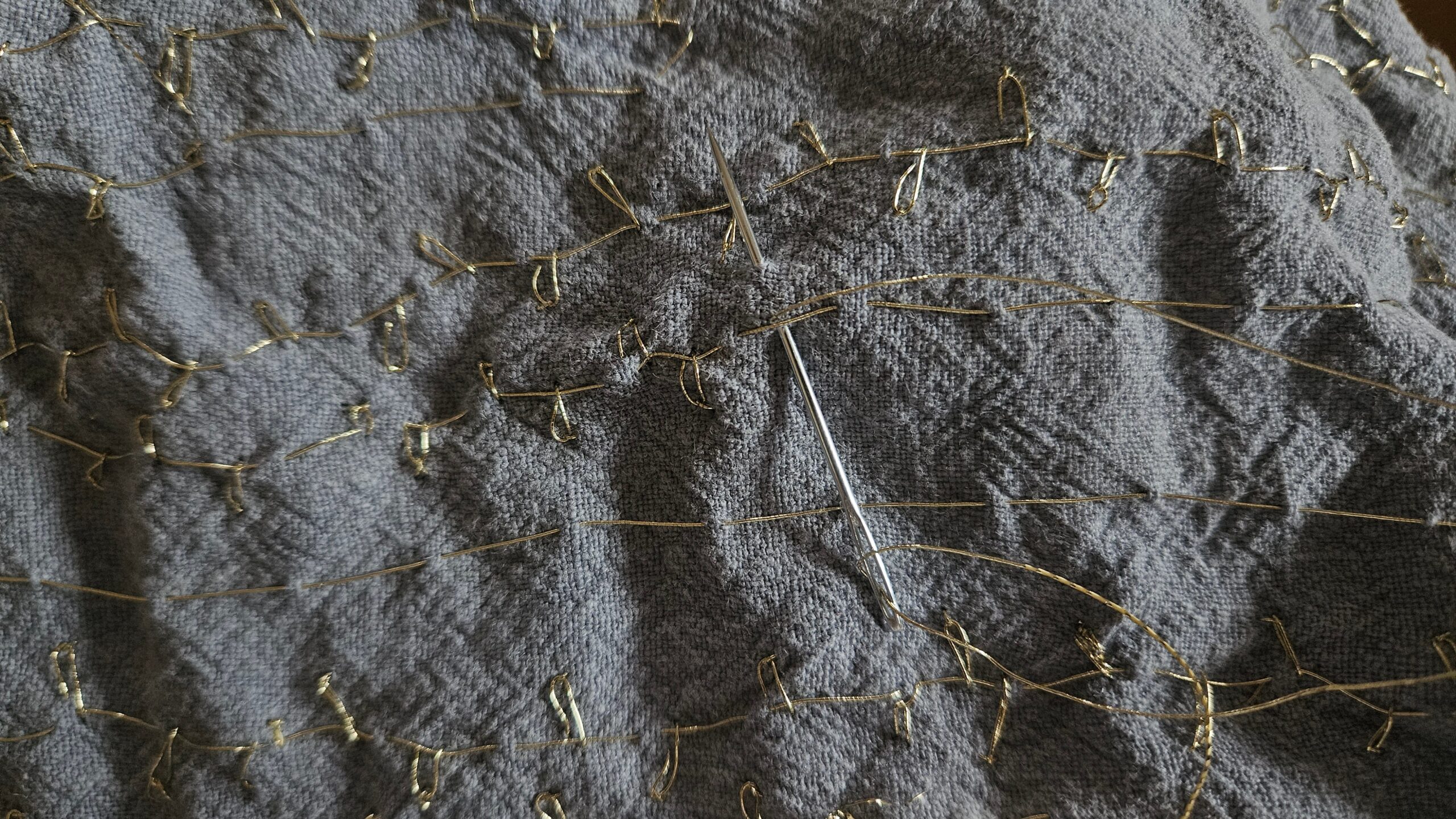 Close-up of the finished gold embroidery texture