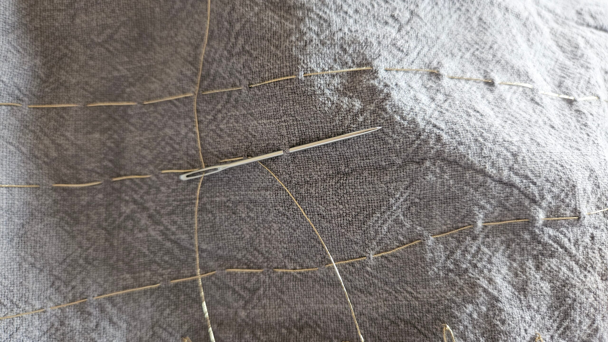 Starting the gold chevron embroidery on the blue linen