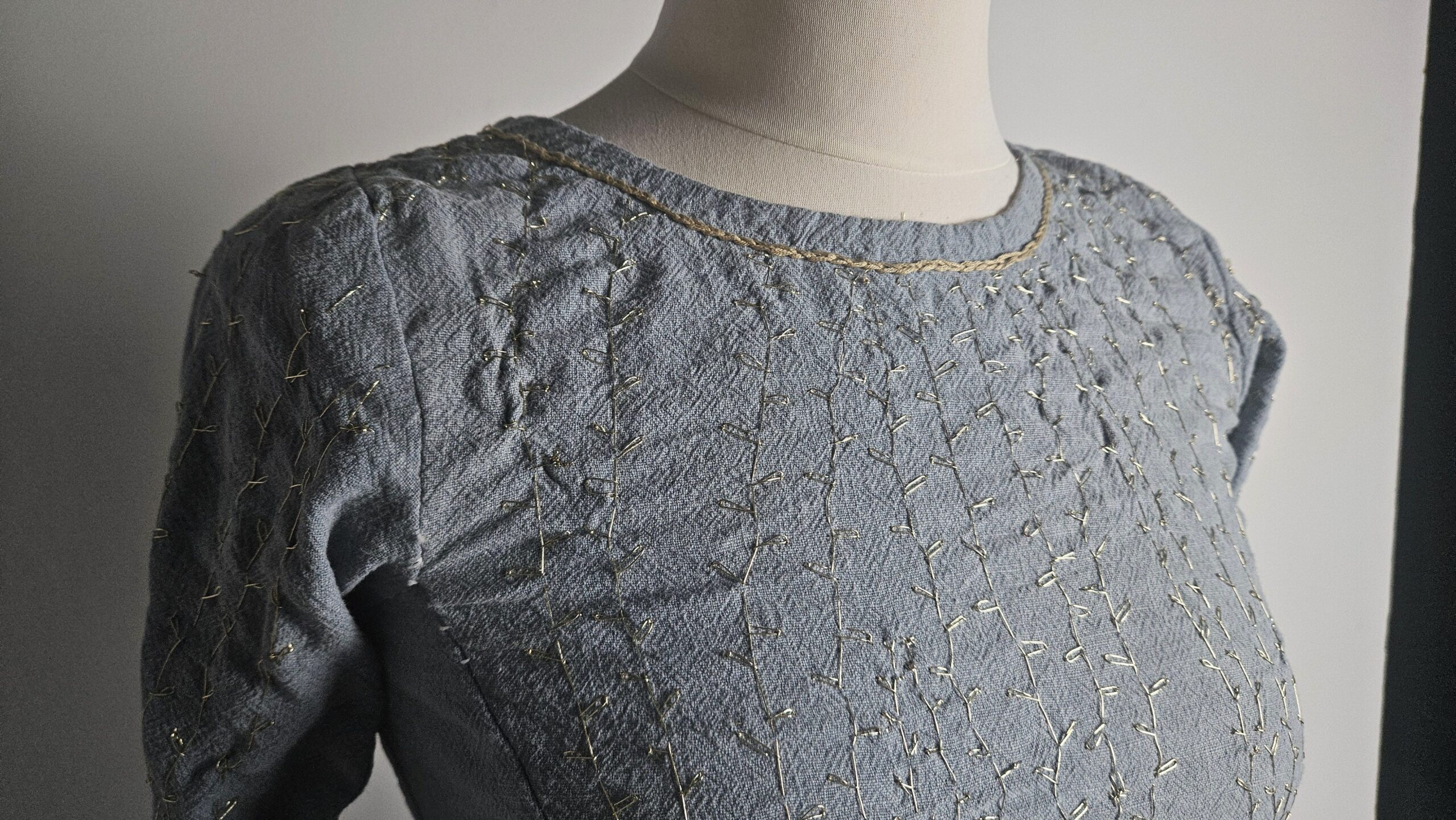 Embroidered blue bodice fitted on the mannequin