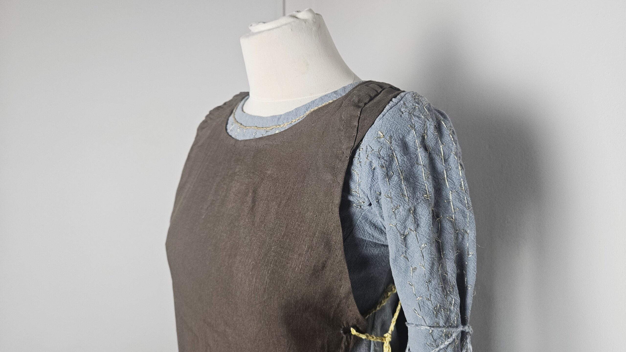 Brown overdress layered over the blue underdress, side view