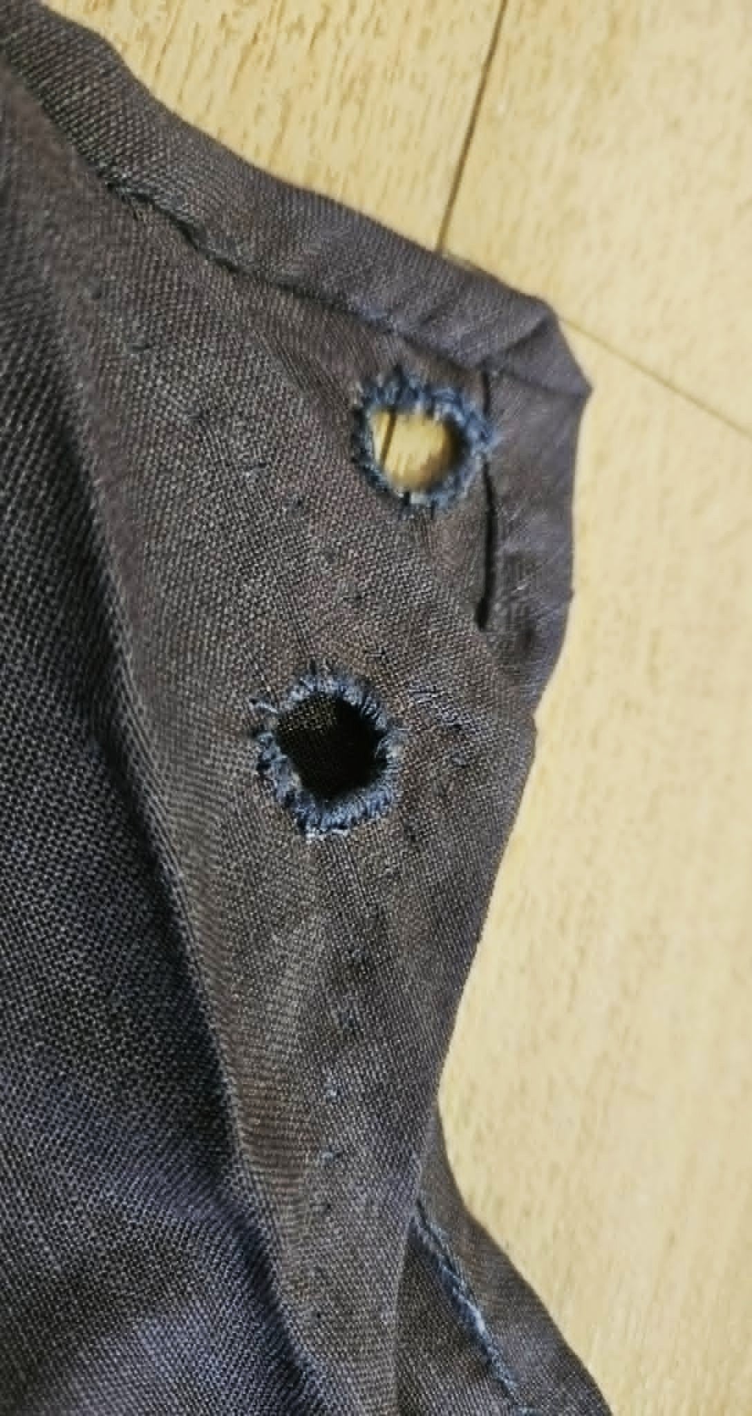 Hand-finished eyelet in the brown overdress for lacing
