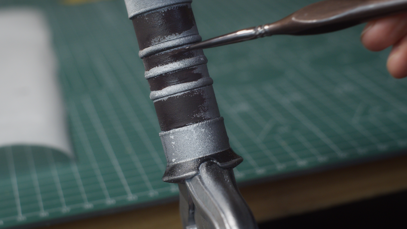 Hand-painting the details on the sword hilt