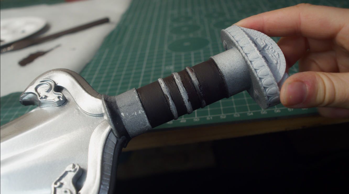 Painted sword grip and crossguard during detailing