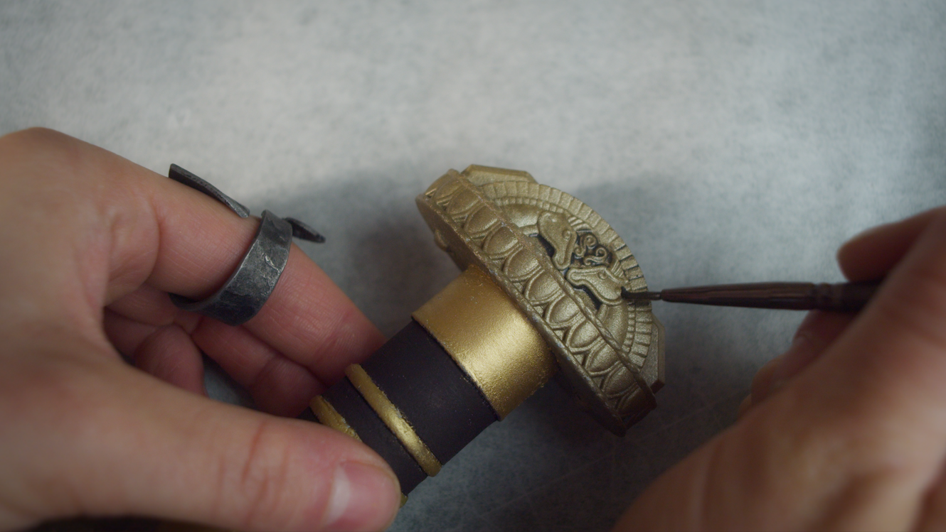 Detail painting on the sword's gold pommel