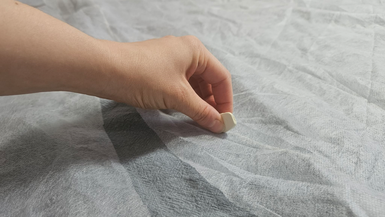 Smoothing the fabric before cutting along the traced pattern