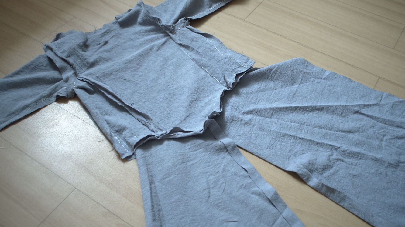 Blue dress with the sleeves attached, laid out flat