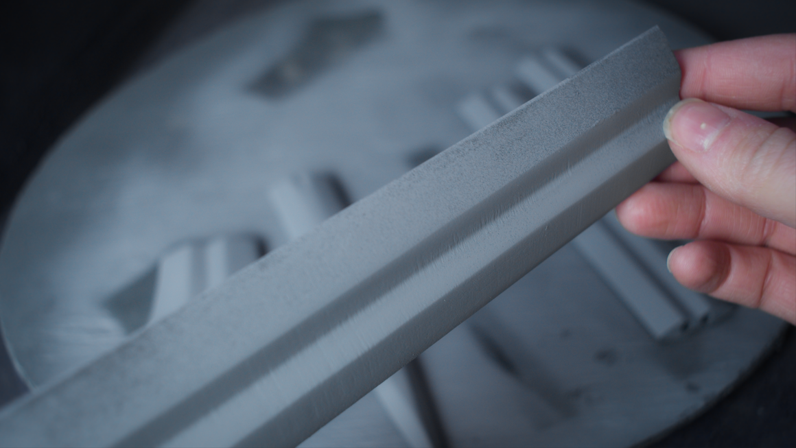 Primed sword blade showing the engraved detail after filling