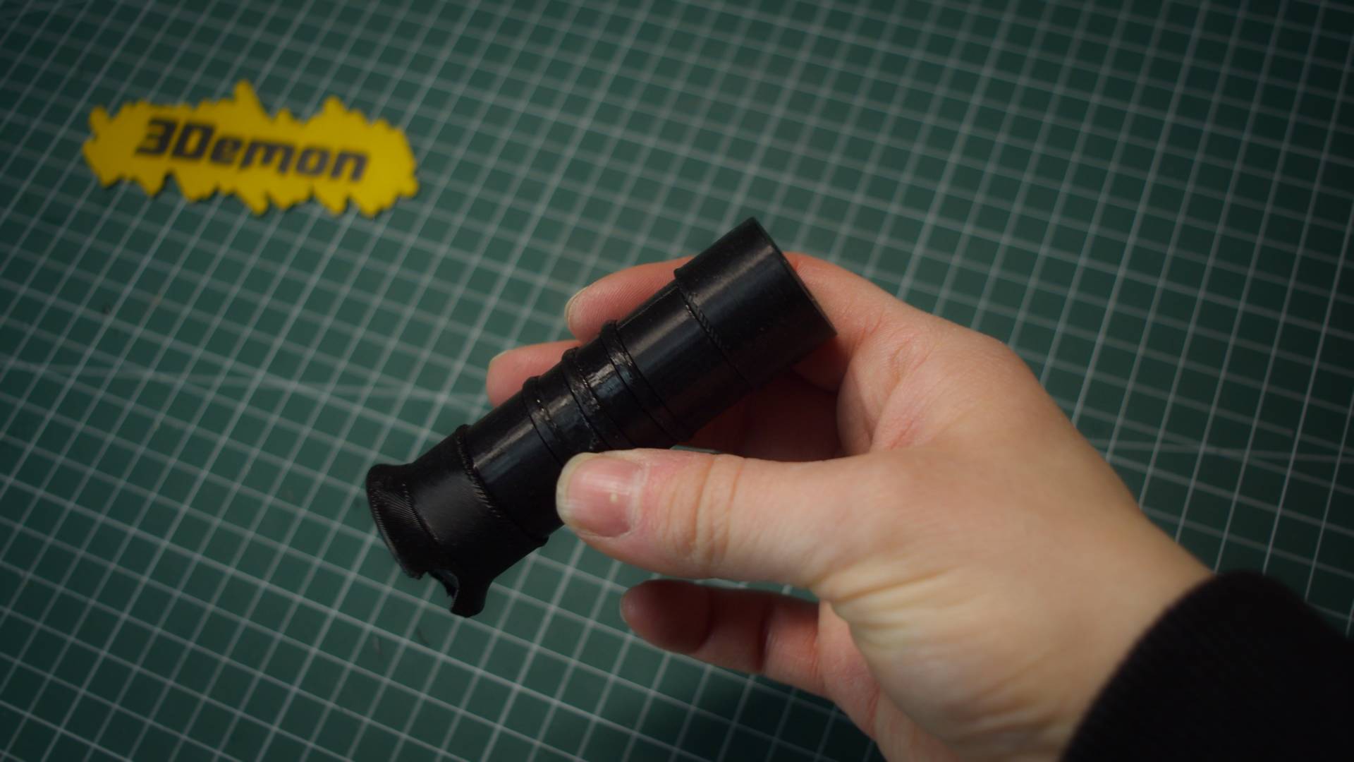Assembled 3D printed sword hilt held in hand