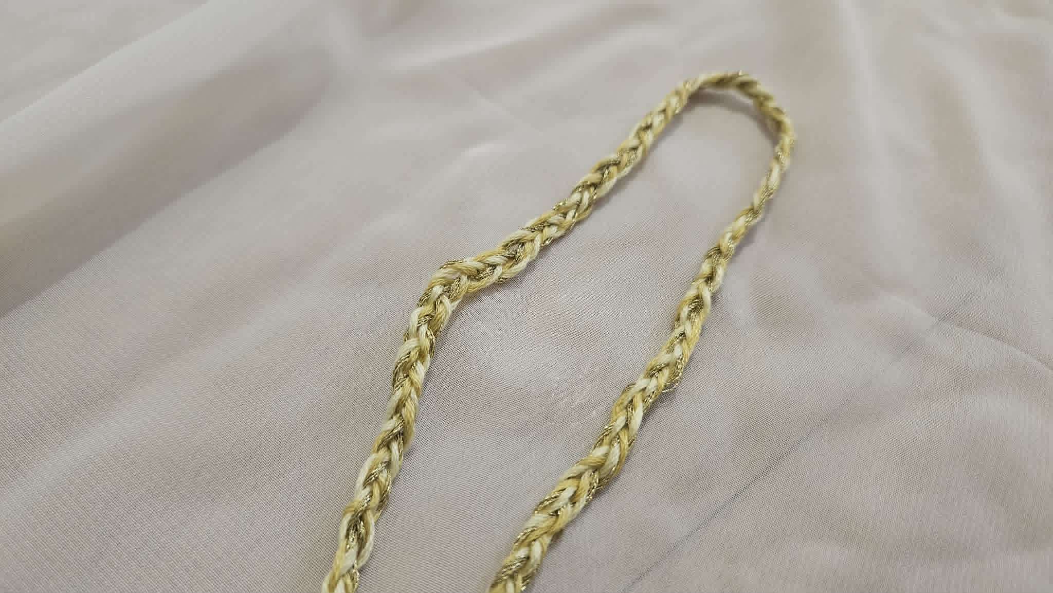 Braided yellow cord ready to be attached to the sleeve