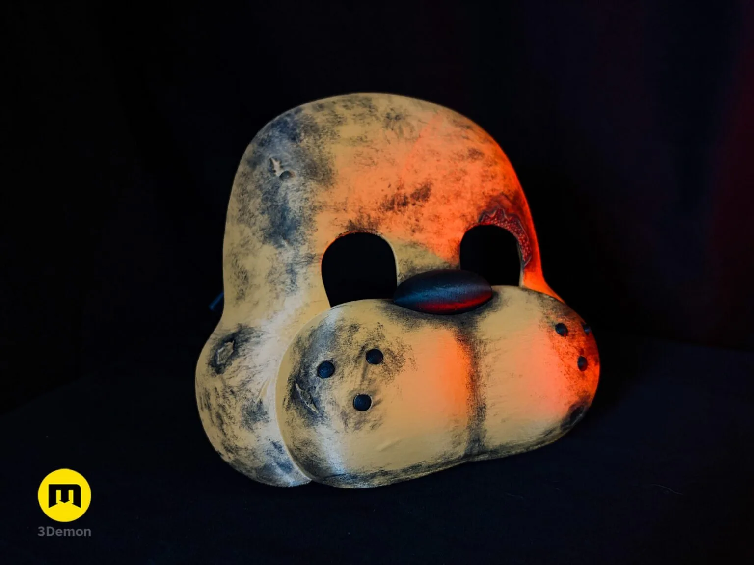 Close-up side view of Freddy Fazbear mask showing fur weathering texture on bear ear built-in rubber strap loop on side edge and rough surface from FDM printing