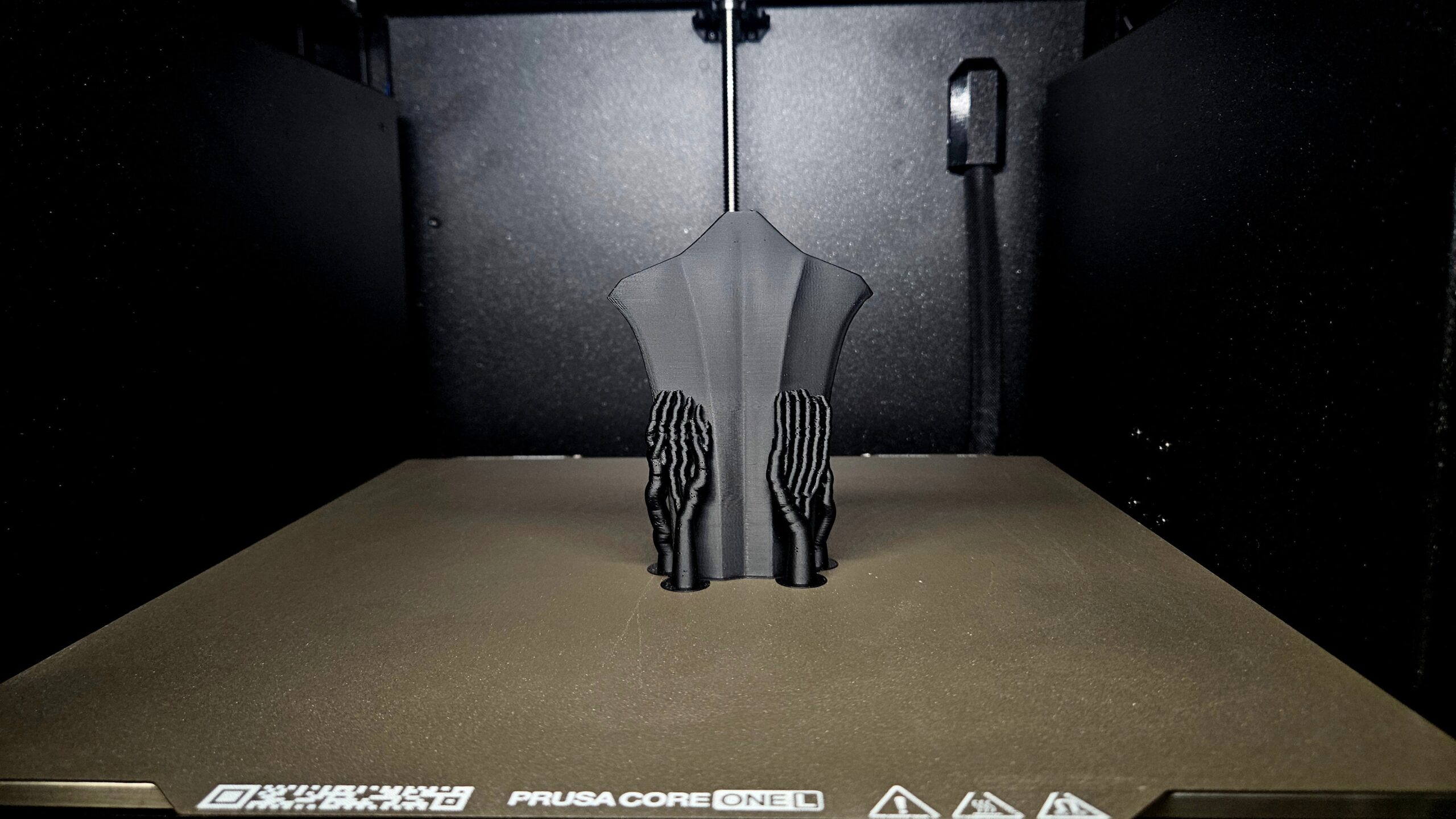 Close-up of a sword part printing inside the 3D printer enclosure