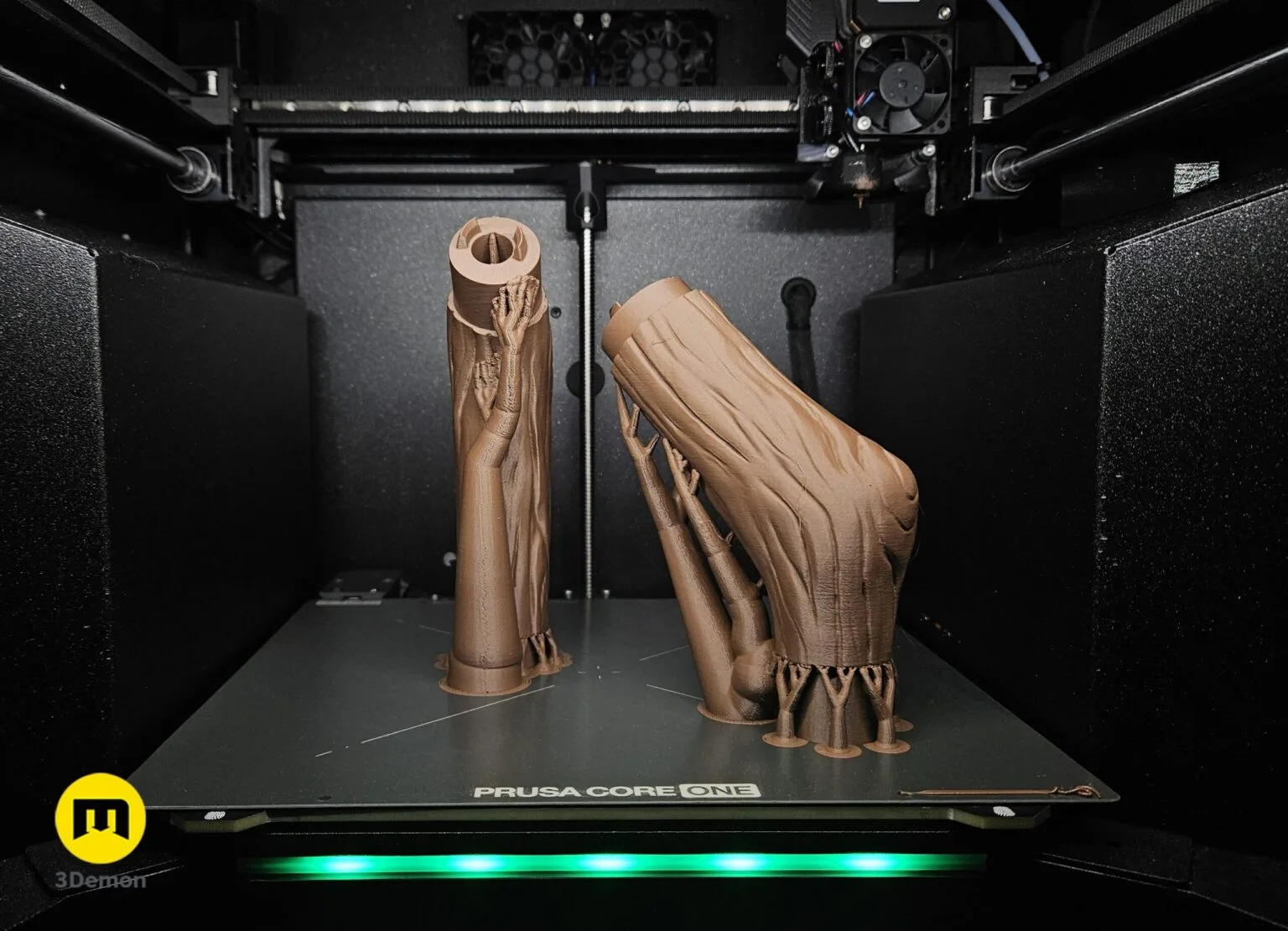 Three-panel composite photo of Fern Staff Frieren printing shaft on Prusa Core One left printed shaft segments and silver rings on cutting mat center assembled painted shaft against dark background right