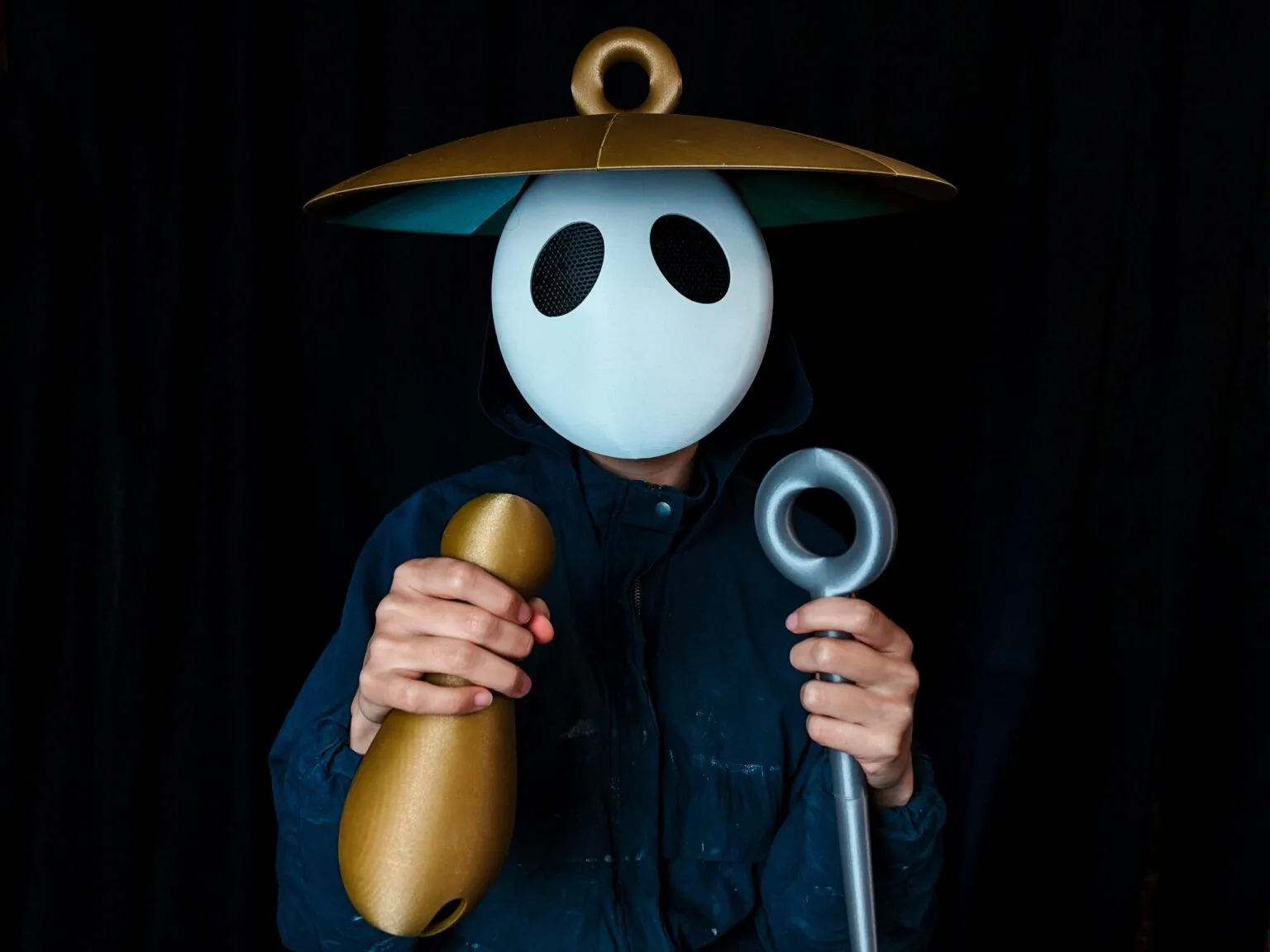 Lifestyle photo of Sherma cosplay from Hollow Knight Silksong with 3D printed mask, hat, and props