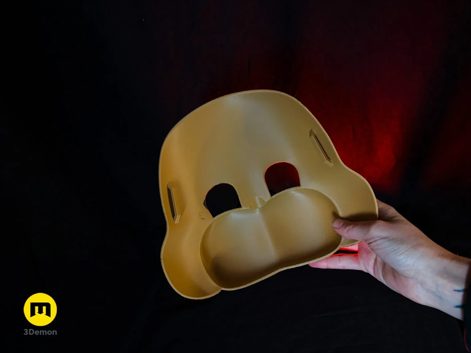 Lifestyle side angle of person wearing Freddy Fazbear movie mask outdoors showing profile of round cheek circular ear and glowing red eye visible through eyehole